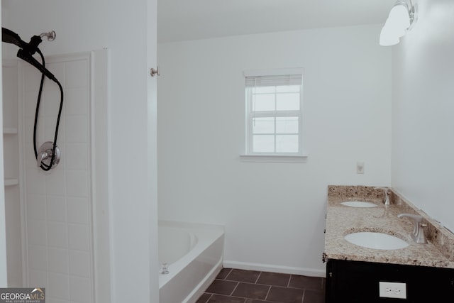 bathroom featuring tile patterned flooring, baseboards, a garden tub, and a sink