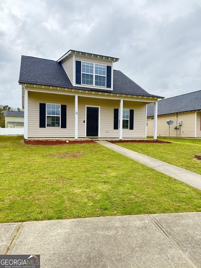 view of front of home with a front lawn and roof with shingles