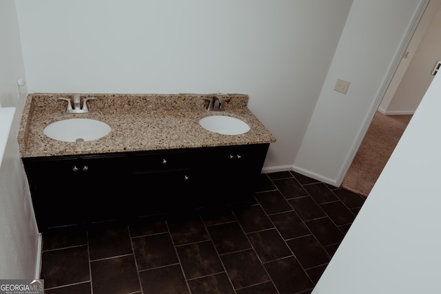 bathroom with baseboards and a sink