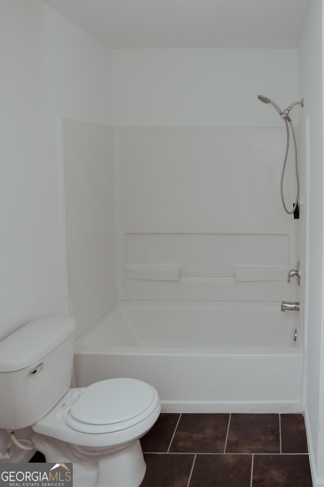 bathroom with tile patterned floors, toilet, and shower / tub combination