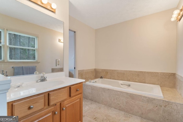 bathroom with tile patterned floors, vanity, and a bath