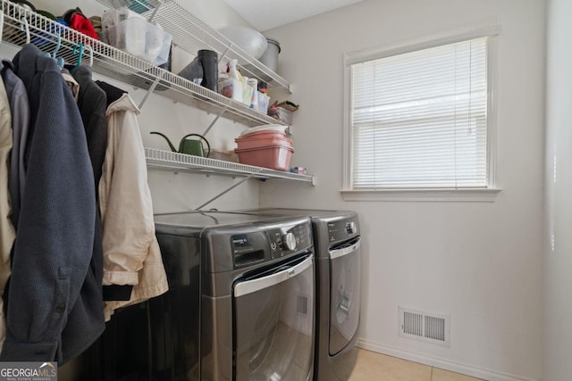 laundry area featuring laundry area, visible vents, baseboards, tile patterned floors, and independent washer and dryer