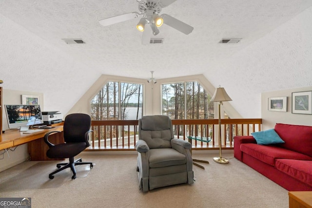 office with lofted ceiling, visible vents, and carpet flooring