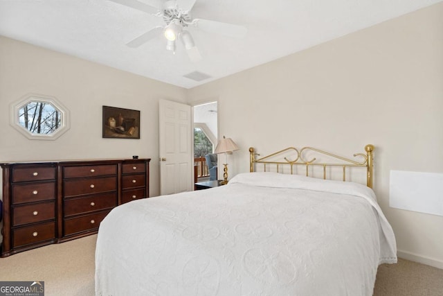 carpeted bedroom with ceiling fan, multiple windows, visible vents, and baseboards