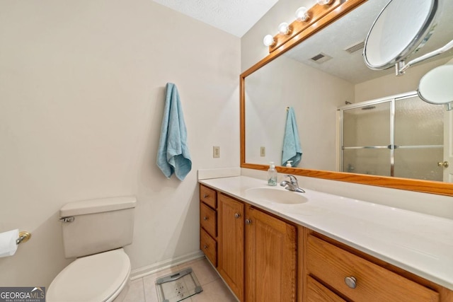 bathroom with visible vents, toilet, a stall shower, vanity, and tile patterned floors