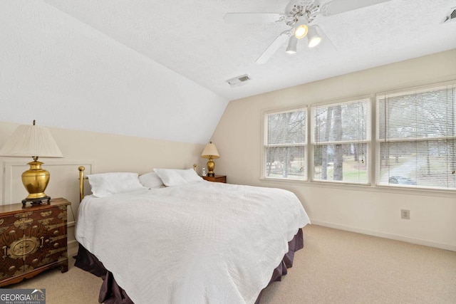 bedroom featuring lofted ceiling, carpet flooring, a textured ceiling, and baseboards