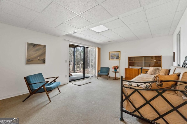 bedroom with light carpet, access to exterior, baseboards, and a drop ceiling