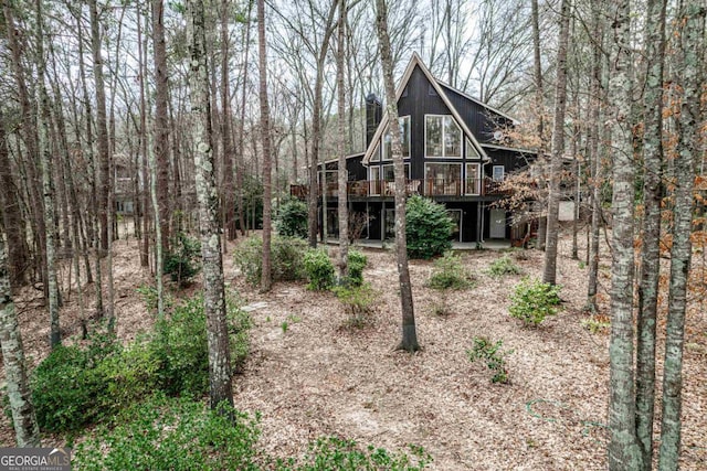 back of house featuring a wooden deck