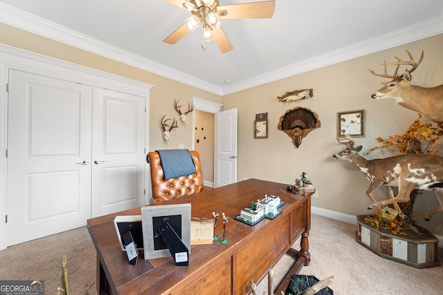 carpeted office featuring baseboards, ornamental molding, and a ceiling fan