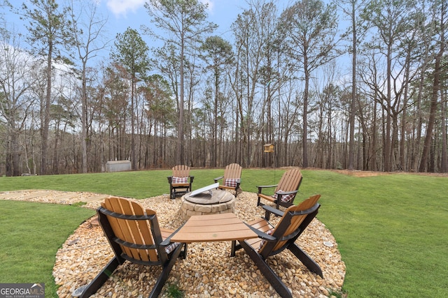 view of yard with a fire pit