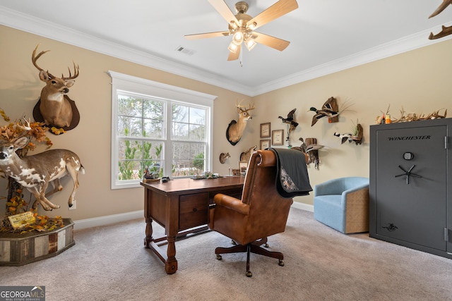 carpeted home office with baseboards, visible vents, a ceiling fan, and ornamental molding