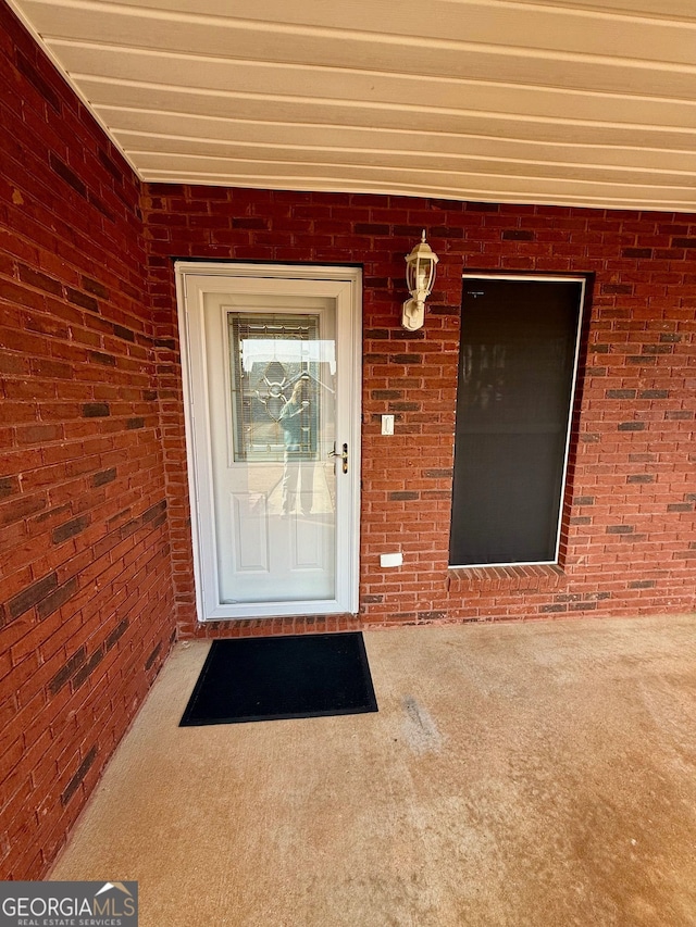 entrance to property with brick siding