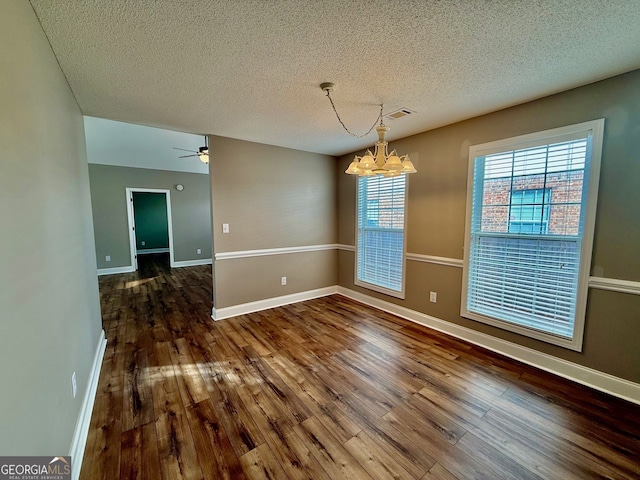 unfurnished dining area featuring wood finished floors, visible vents, and baseboards