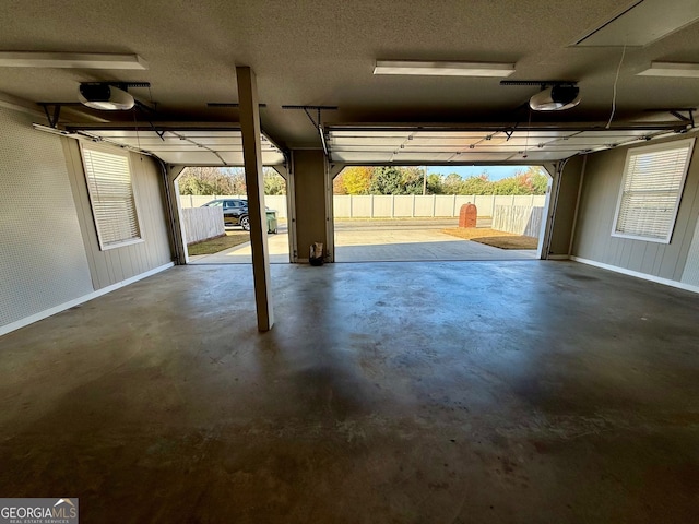 garage with a garage door opener and baseboards