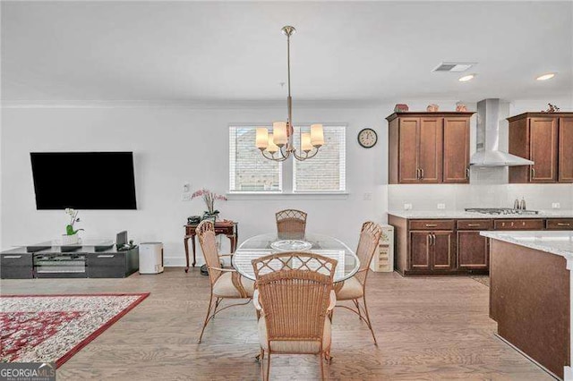 dining space with light wood-style floors, visible vents, a notable chandelier, and recessed lighting