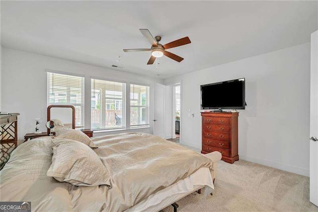 carpeted bedroom featuring ceiling fan and baseboards