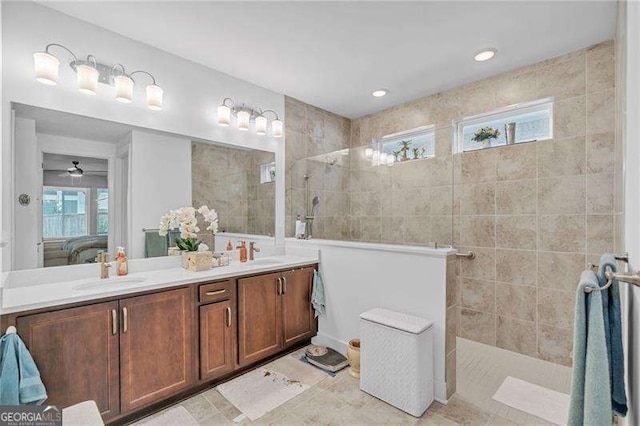 bathroom featuring a sink, a walk in shower, and ensuite bath