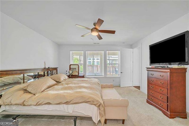 bedroom featuring light carpet and ceiling fan