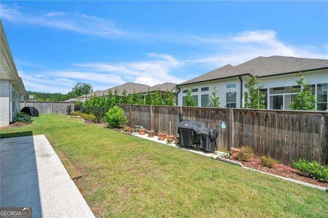 view of yard with a fenced backyard