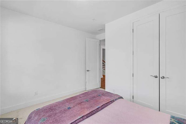 bedroom featuring a closet and baseboards