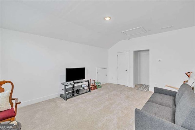 living room featuring attic access, vaulted ceiling, carpet floors, and baseboards