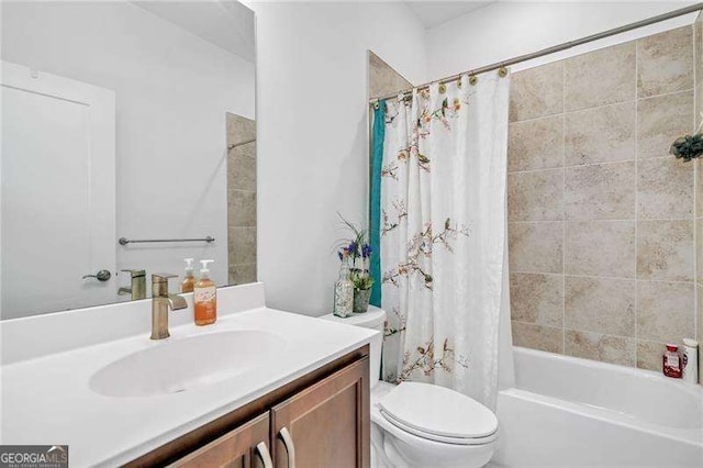 full bath with toilet, shower / bath combo with shower curtain, and vanity