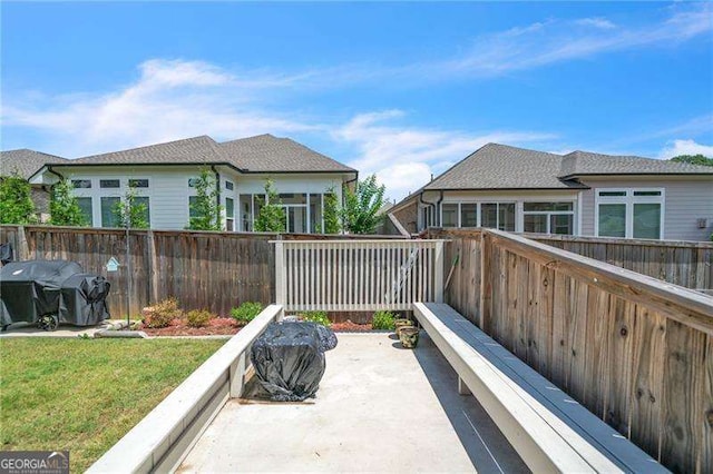 view of patio / terrace featuring area for grilling and fence