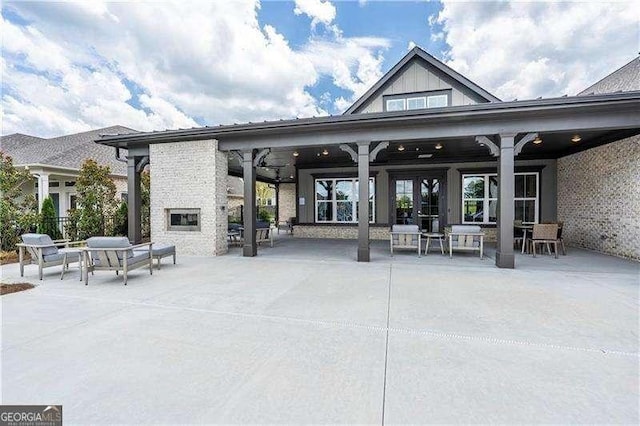 exterior space with an outdoor stone fireplace and a patio