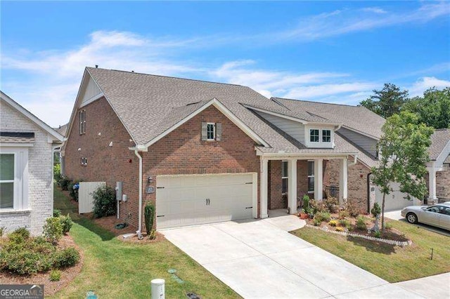 view of front of house featuring driveway, a garage, a shingled roof, a front yard, and brick siding