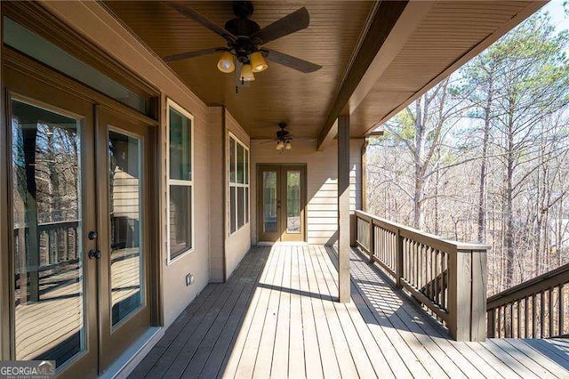 wooden terrace featuring ceiling fan and french doors