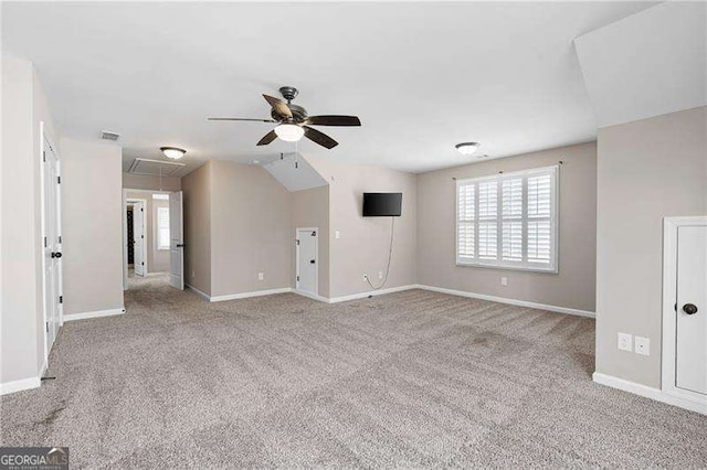 unfurnished living room featuring visible vents, carpet floors, attic access, and baseboards