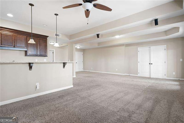 unfurnished living room featuring light carpet, a ceiling fan, visible vents, and baseboards