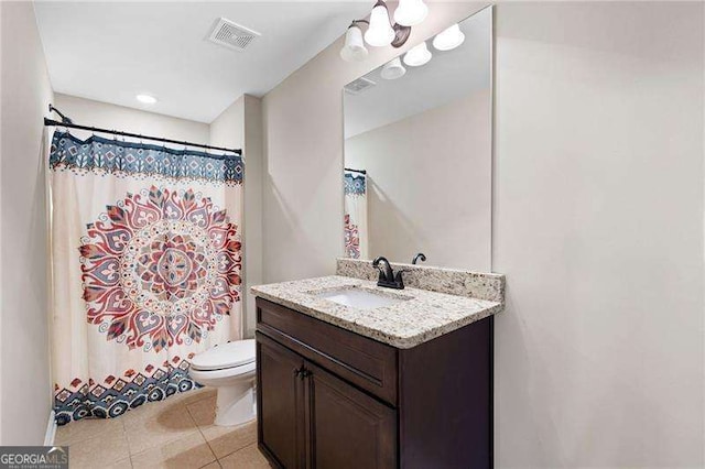 bathroom with visible vents, a shower with shower curtain, toilet, vanity, and tile patterned flooring