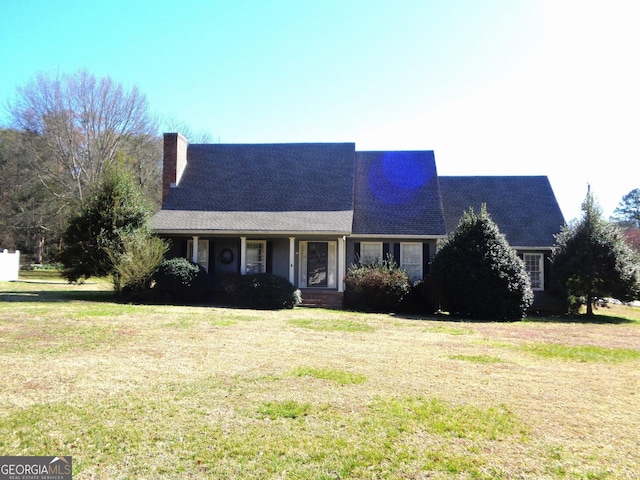 view of front of home featuring a chimney and a front yard