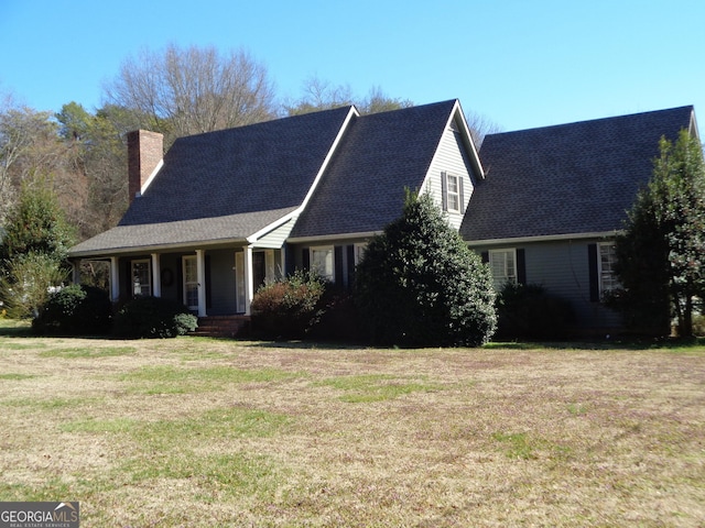 view of front facade with a chimney and a front yard