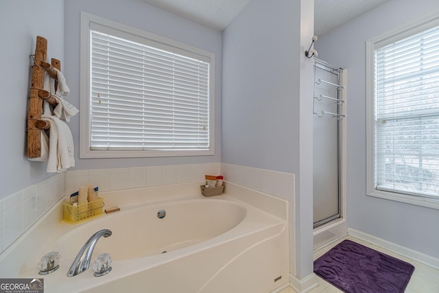 bathroom with an enclosed shower and a bath