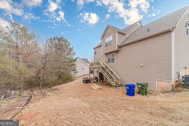 view of side of property featuring stairway and a wooden deck