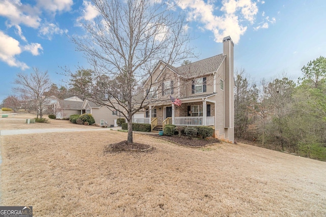 view of front of house featuring covered porch and a chimney