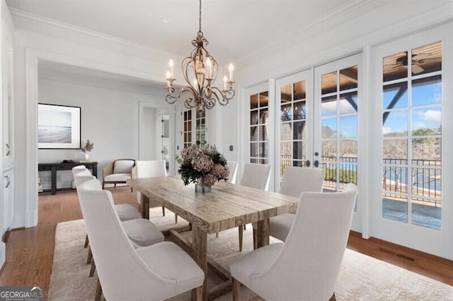 230 Hawks Lake Dr, Ball Ground, GA 30107 - dining area featuring a chandelier, ornamental molding, and wood finished floors