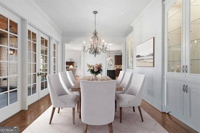 230 Hawks Lake Dr, Ball Ground, GA 30107 - dining area featuring french doors, crown molding, wood finished floors, and a chandelier