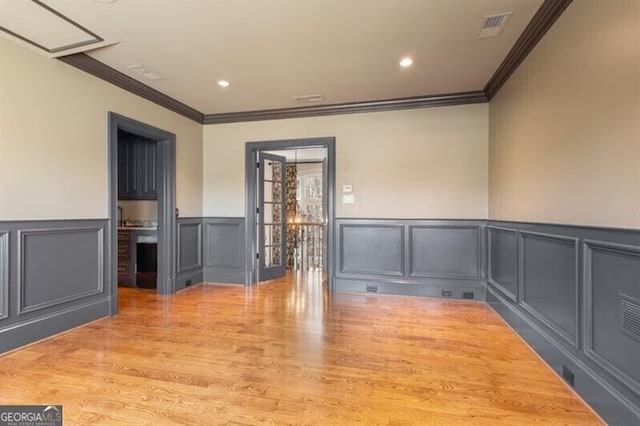 230 Hawks Lake Dr, Ball Ground, GA 30107 - empty room featuring ornamental molding, a decorative wall, a wainscoted wall, and wood finished floors