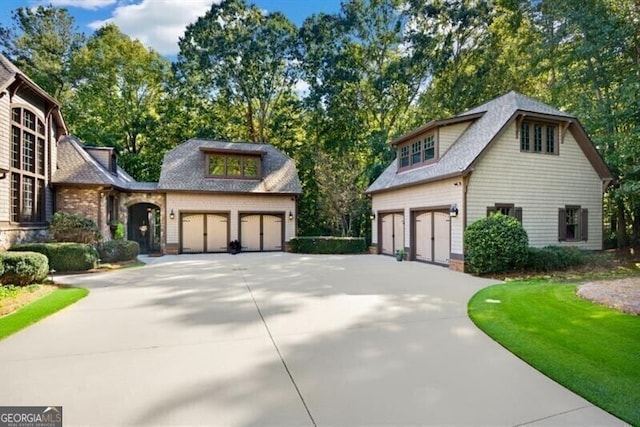 230 Hawks Lake Dr, Ball Ground, GA 30107 - view of front of house featuring concrete driveway, a shingled roof, and view of wooded area