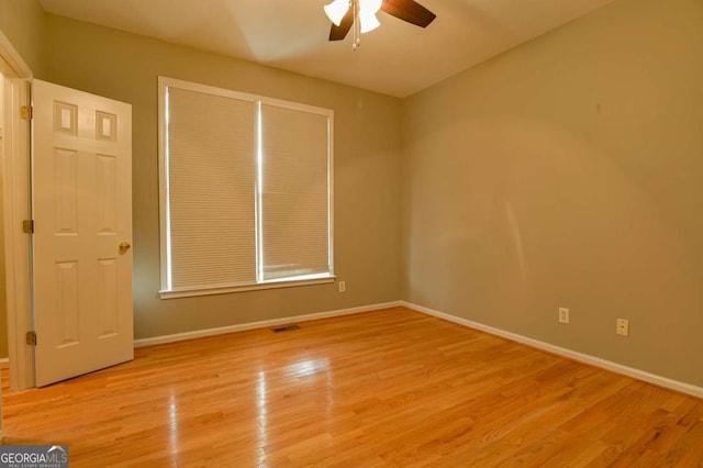 unfurnished bedroom featuring a ceiling fan, baseboards, visible vents, and light wood finished floors