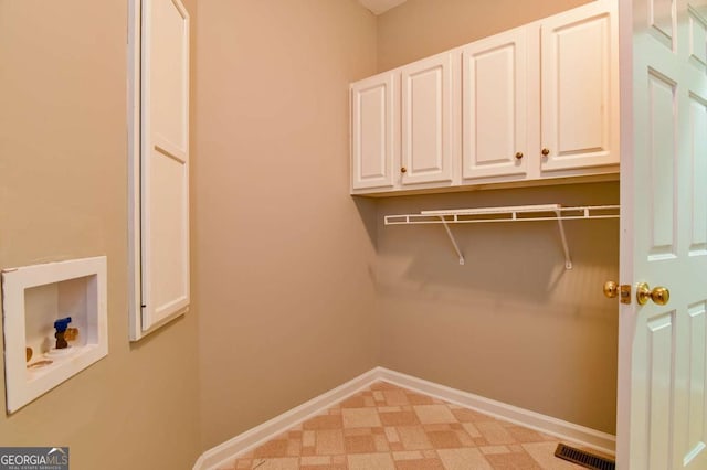 laundry area featuring cabinet space, visible vents, hookup for a washing machine, and baseboards