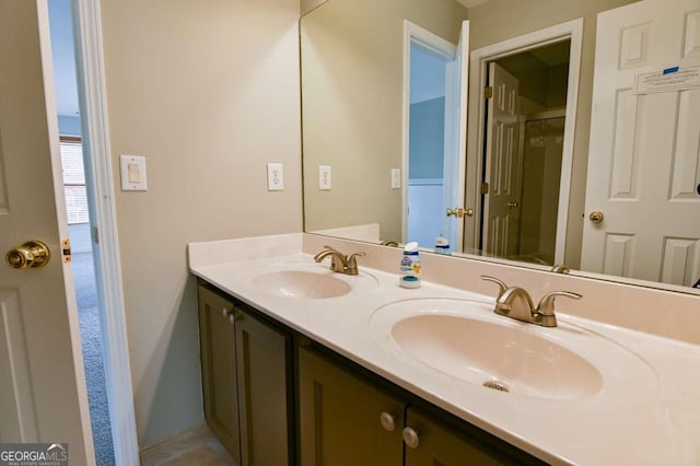 full bathroom featuring a sink, a shower stall, and double vanity