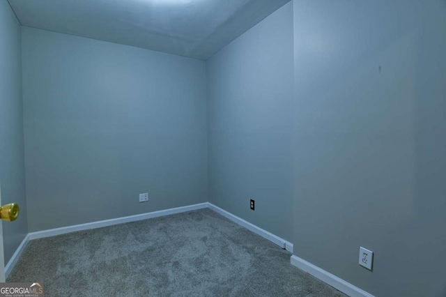 spare room featuring baseboards and carpet