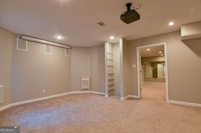 finished basement with recessed lighting, visible vents, baseboards, and light colored carpet