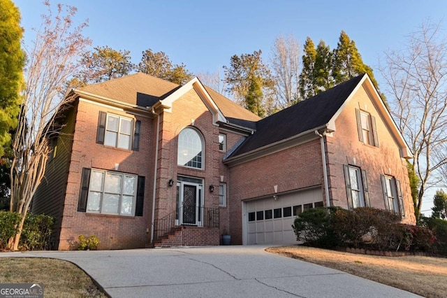 traditional home featuring brick siding and driveway