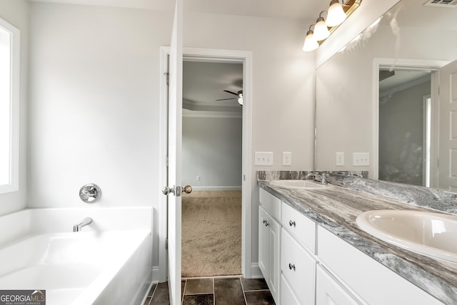 bathroom featuring visible vents, a sink, a garden tub, and double vanity