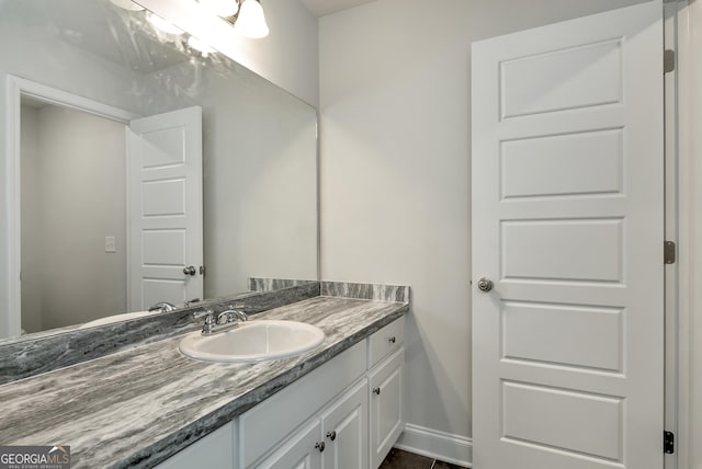 bathroom with vanity and baseboards